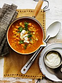 Curry soup with lentils, vegetables and sour cream