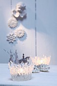 Two festive tealight holders made from moulded, transparent hot-melt adhesive