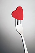 A red sugar heart on a fork