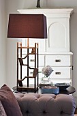 Table lamp with delicate wooden base and brown lampshade in living room