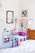 Bed, white bedside table, feminine pin board and String shelving on wall