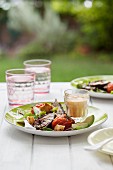 Grilled aubergine and tomato salad with a hummus dressing