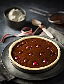 A chocolate tart with cherries