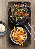 Mussels in a vegetable and herb broth served with fries and aioli