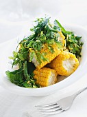Corn on the cob with butter and fresh herbs