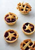 Mini cherry pies on a marble platter