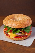A cheeseburger on a sesame seed bagel