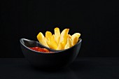 Ketchup on French fries, close-up, elevated view