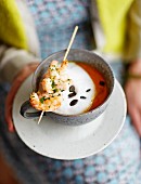 Pumpkin cappuccino with a prawn skewer