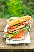 A catfish sandwich with grilled vegetables