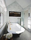 Badezimmer mit freistehender Vintage Badewanne vor Fenster im Dachgeschosses, an Wand weiss-graue Tapete