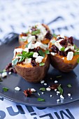 Baked sweet potatoes with feta cheese, cranberries and parsley