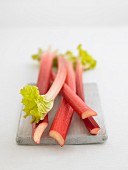 Spears of rhubarb on a wooden board