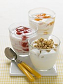 Three glasses of yoghurt with various different toppings