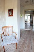 Retro armchair with fur blanket in corridor of Swedish wooden house