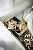 Boxes of matches with religious motifs lying on white-painted, wooden tray