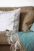 White cushion with trim on ecru sofa