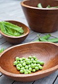Freshly shelled peas in a wooden bowl
