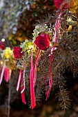 Christmas tree festively decorated with roses and ribbons