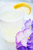 A drink made with limoncello and decorated with flowers