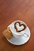 A cup of coffee decorated with a milk foam heart