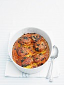 Mini soufflés and tomato sauce gratinated in a baking dish