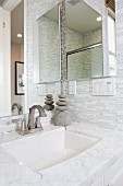 Contemporary bathroom with marble washbasin and mirror; Irvine; California; USA