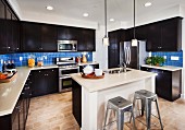 Modern kitchen with dark wooden cabinets; San Marcos; California; USA