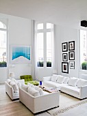 White sofa set in living room with French windows leading to balcony in period apartment