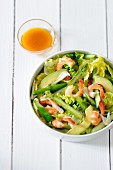 A salad made with avocado, green asparagus and prawns