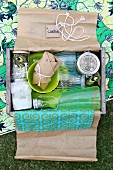 Wrapped drinks & food in wooden crate used as picnic hamper