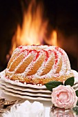 A Bundt cake in front of an open fire