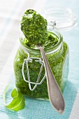 Rocket pesto in a jar and on a spoon