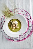 Cream of courgette soup with meringue and matcha