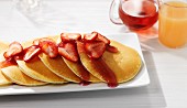 Pancakes with strawberries and strawberry syrup