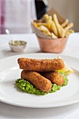 Fish fingers, mushy peas and chips in a restaurant