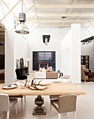 Exhibition room for designer furniture (antlers on dining table, chairs, sofas, cabinet)