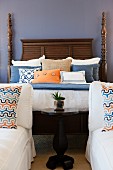 Cushions and pillows arranged on four poster bed; Valencia; California; USA