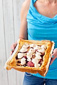 A puff pastry tart with almond cream, nectarines, cherries and meringue
