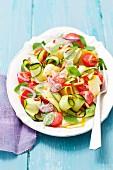Courgette salad with cherry tomatoes, red onions, basil and parsley