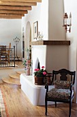 View of fireplace beside wooden stairs in the living room; Santa Fe; New Mexico; USA