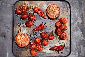 Roasted tomatoes and chillis on a baking tray