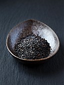 Black sesame seeds in a small dish