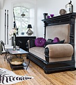 Majestic antique sofa with purple scatter cushions and metal coffee table