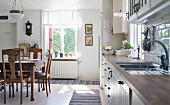 Dining area with wooden, Wilhelmine-era table in large kitchen-dining room