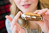 A young woman eating a smore