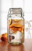 Peach drink in a jar with a tap