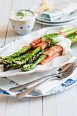 Salmon rolls with green asparagus and dill sauce