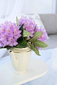 Purple rhododendron flowers in white, vintage, china coffee pot