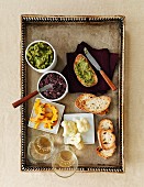 Green and black tapenade with grilled bread and white wine